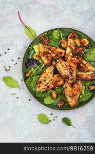 Tasty chicken wings with spices and vegetables. BBQ. Grilled chicken wings, barbecue