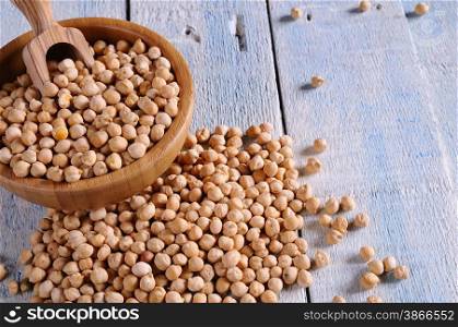 Tasty chickpeas prepared for cooking on wooden table.