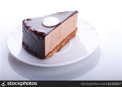 tasty chocolate cake on the plate on white background. Shallow focus