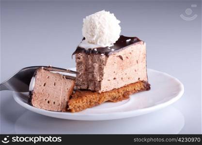 tasty chocolate cake on white plate with fork. Shallow focus