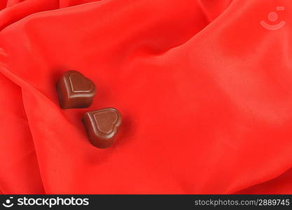 Tasty chocolate on red close up