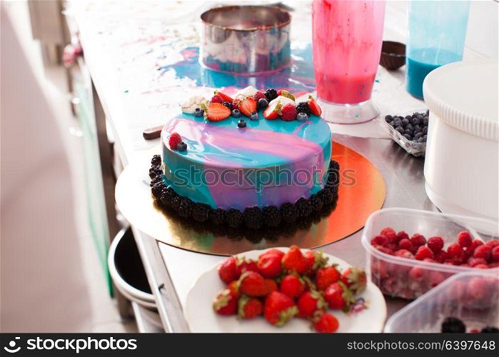Tasty colorful cake with fresh summer berries. Decorating the cake