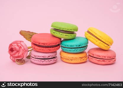 tasty colorful macarons on pink background