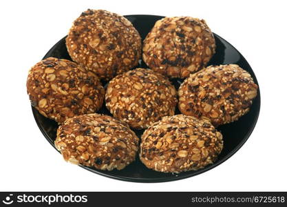 Tasty cookies on a black plate isolated on a white background