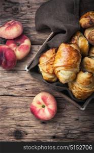 Tasty croissants with peaches