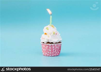 Tasty cup cake on blue background with copy space