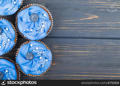 Tasty cupcakes on a white wooden table
