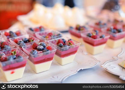 Tasty cupcakes on white cloth. Wedding reception table