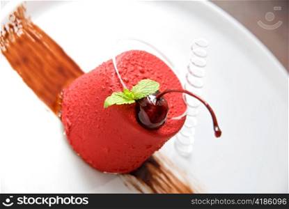 Tasty dessert of whipped cream, chocolate cherry, caramel and mint