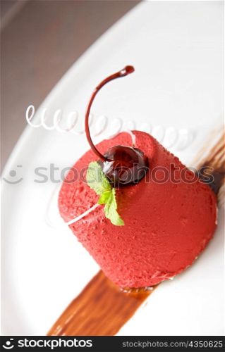 Tasty dessert of whipped cream, chocolate cherry, caramel and mint