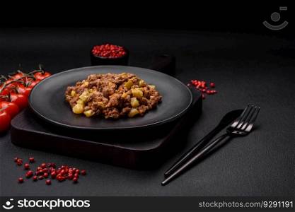 Tasty dish consisting of zucchini, beef meat, mushrooms, onions and garlic with salt and spices on a dark concrete background