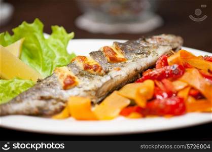 Tasty dish of rainbow trout fish with vegetables