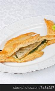 tasty dish of trout fish baked with greens at dough