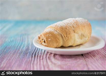 Tasty eclair on plate. Tasty eclair on a color gradient background