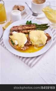 Tasty eggs Be≠dict, hollandaise sauce and aspargus covered with bacon.. Tasty eggs Be≠dict, hollandaise sauce and aspargus covered with bacon
