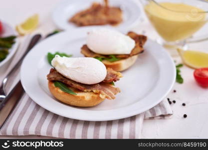 Tasty eggs Benedict, hollandaise sauce and bacon.. Tasty eggs Benedict, hollandaise sauce and bacon