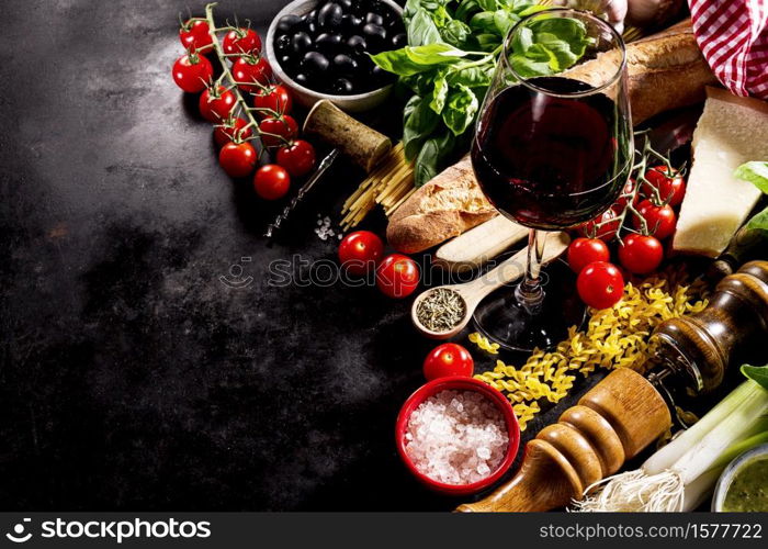 Tasty fresh appetizing italian food ingredients on dark background. Ready to cook. Home Italian Healthy Food Cooking Concept.. Tasty fresh appetizing italian food ingredients on dark background.