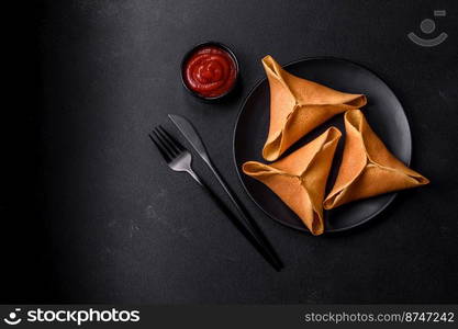 Tasty fresh pancakes with meat, sheep, spices and herbs on a dark concrete background. Tasty fresh pancakes with meat, sheep, spices and herbs