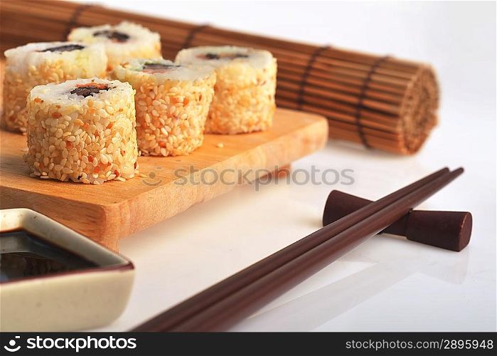 tasty fresh uramaki with tuna on wooden plate