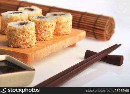 tasty fresh uramaki with tuna on wooden plate