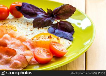 tasty fried eggs with bacon for breakfast