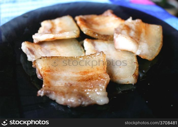 tasty fried pieces of lard on the plate