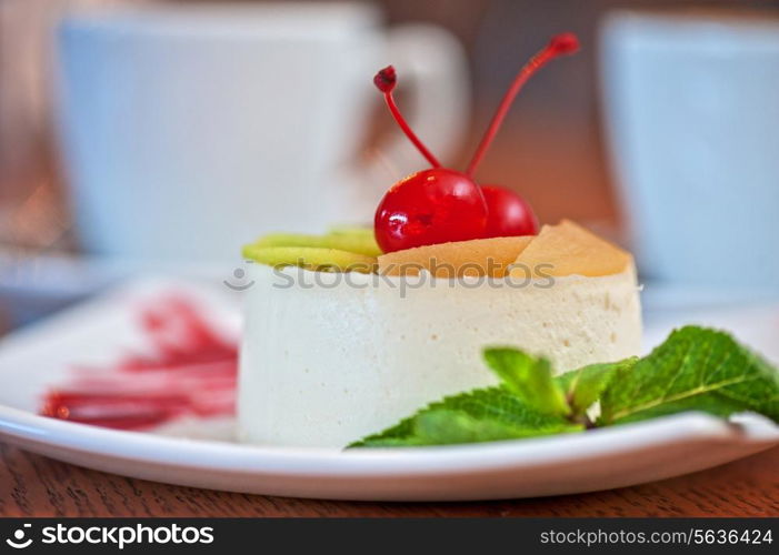 tasty fruit dessert with cherry and kiwi with coffee