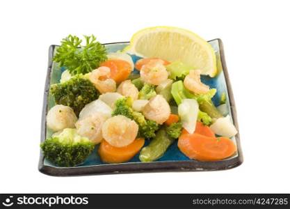 tasty garlic shrimp with broccoli, carrots, and lemon slice