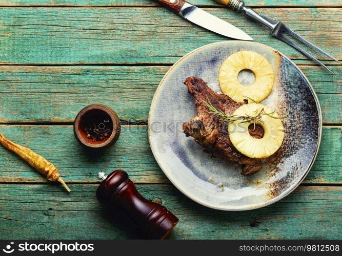 Tasty grilled beef meat with pineapple in pineapple sauce. Copy space. Roasted meat chop in marinade, space for text
