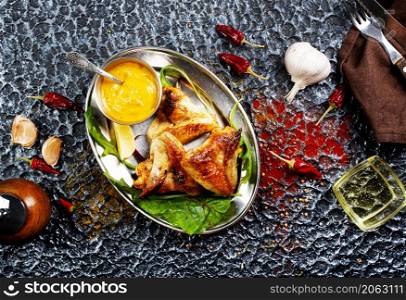 tasty grilled chicken wings on a white dish. tasty grilled chicken wings on a metal dish