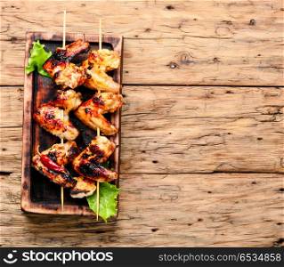 Tasty grilled chicken wings. Spicy marinated chicken wings grilling, barbecue.BBQ.American food