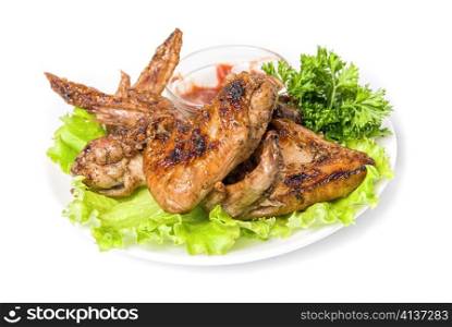 Tasty grilled chicken wings with vegetables and sauce