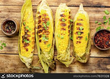 Tasty grilled corn on retro wooden table,summer food. Grilled corn cobs