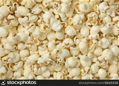 Tasty group of white popped salted popcorn full frame close up 