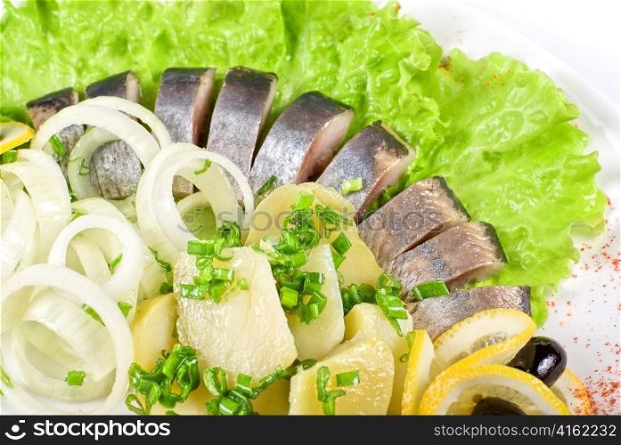 Tasty herring with potato and fresh vegetables