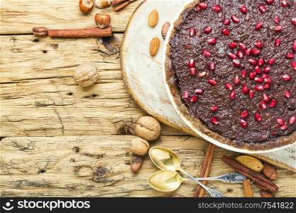 Tasty homemade chocolate cake with pomegranate and nut.. Chocolate cake with pomegranate