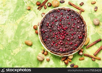 Tasty homemade chocolate cake with pomegranate and nut.. Chocolate cake with pomegranate