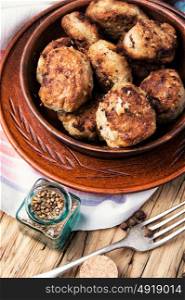 tasty homemade cutlets. Homemade cutlets in clay ware on a wooden background.Ukrainian food