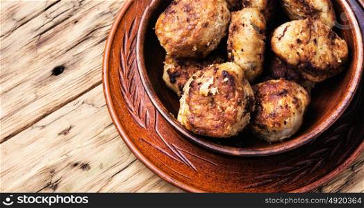 tasty homemade cutlets. homemade rissole in clay ware on a wooden background
