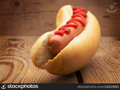 Tasty hot dog on wooden table