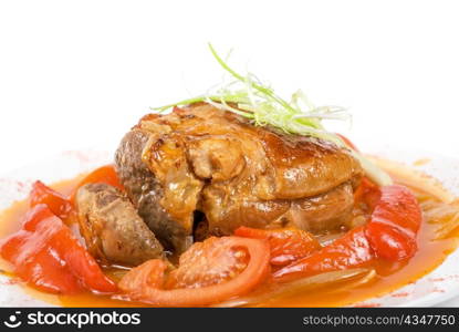 Tasty knuckle of veal baked with vegetables closeup