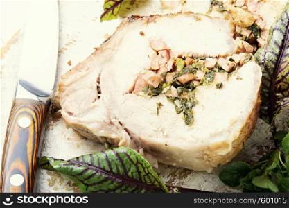 Tasty loin meat stuffed with sorrel and bacon. Appetizing baked meat.