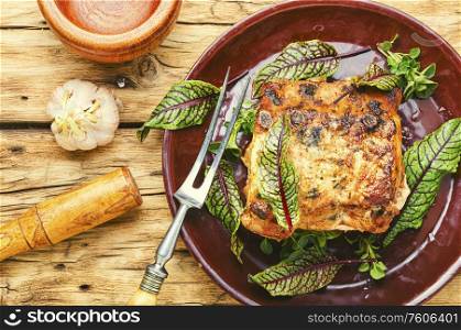 Tasty loin meat stuffed with sorrel and bacon. Appetizing baked meat.
