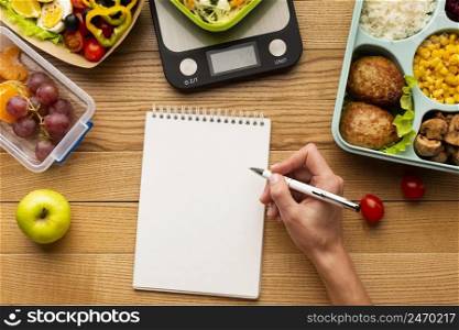 tasty meal arrangement with empty notebook