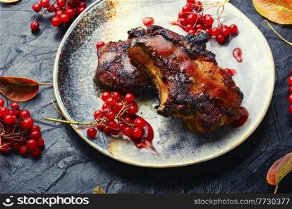 Tasty meat on the bone baked with viburnum syrup.. Grilled meat with viburnum
