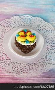 Tasty mini cake on a color gradient background. Tasty mini cake