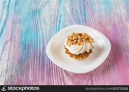Tasty mini cake. Tasty mini cake with nuts on a color gradient background