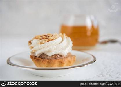 Tasty mini cake with tea on a white background. Tasty cakes with tea