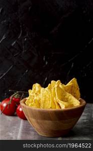 tasty nachos wooden bowl tomatoes. High resolution photo. tasty nachos wooden bowl tomatoes. High quality photo