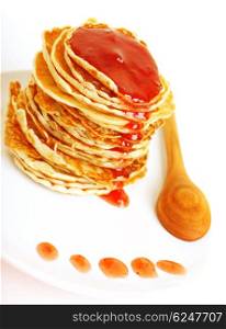 Tasty pancakes with strawberry syrop isolated on white background, roasted crepes with sweet honey on the plate, delicious dessert